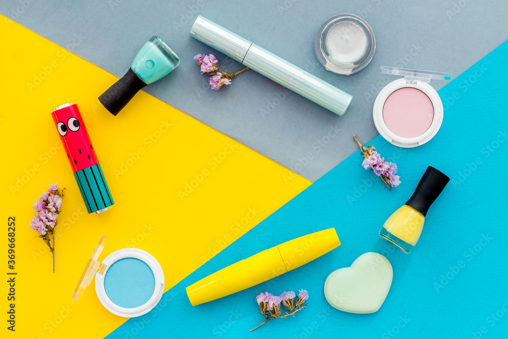 Beauty cosmetics and makeup products on colorful background. Flat lay, top view