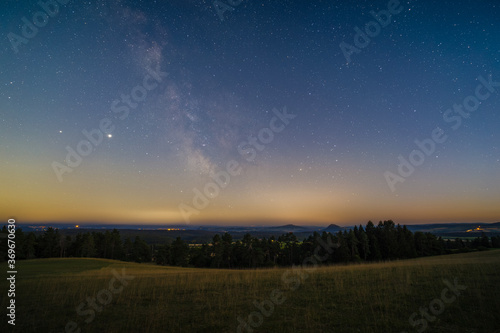 The Milky Way over the Hegau Mountains as seen from the summit of the mountain Witthoh near Tuttlingen in Germany.