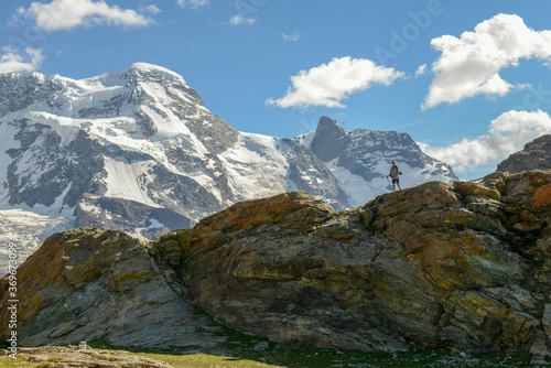 Man hiking near the peak of Gornergrat over Zermatt on the Swiss alps