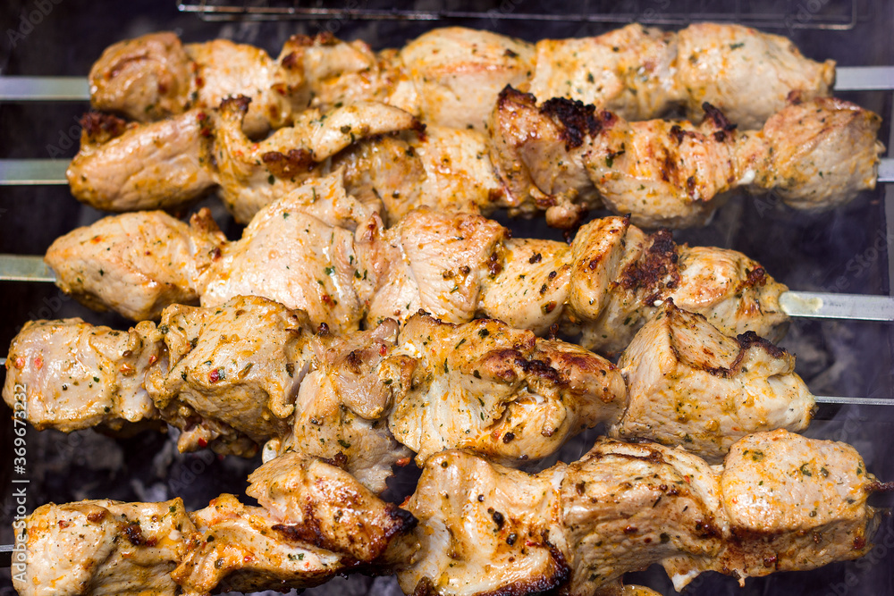 Juicy appetizing meat in pieces in spices on the grill, picnic and outdoor recreation, barbecue delivery Juicy appetizing meat in pieces in spices on the grill, picnic and outdoor recreation, barbecue delivery