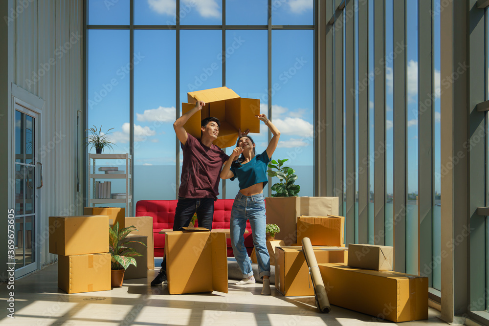 couple working together to unpacking from house moving and relocation