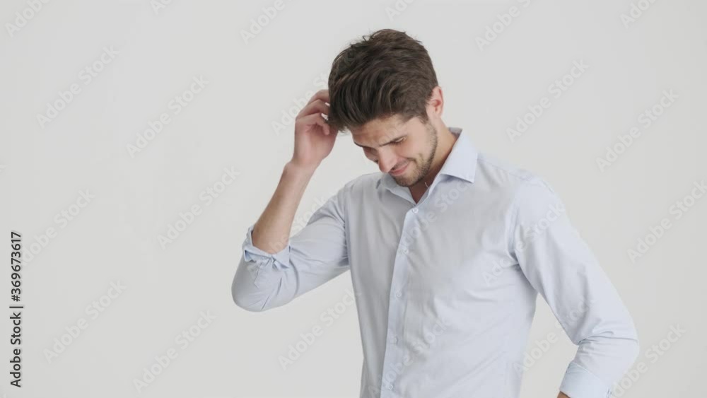 A smiling man is moving and posing isolated over white background A smiling man is moving and posing isolated over white background