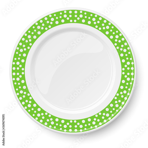 Green plate with white polka dot pattern isolated on white background