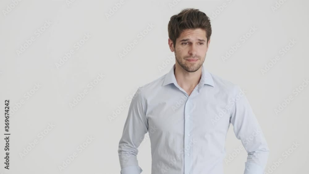 A confused man is worried about something standing isolated over white background A confused man is worried about something standing isolated over white background