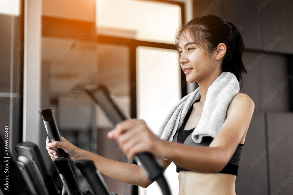 Young woman doing exercise cardio on elliptical trainer at gym. Young woman doing exercise cardio on elliptical trainer at gym.