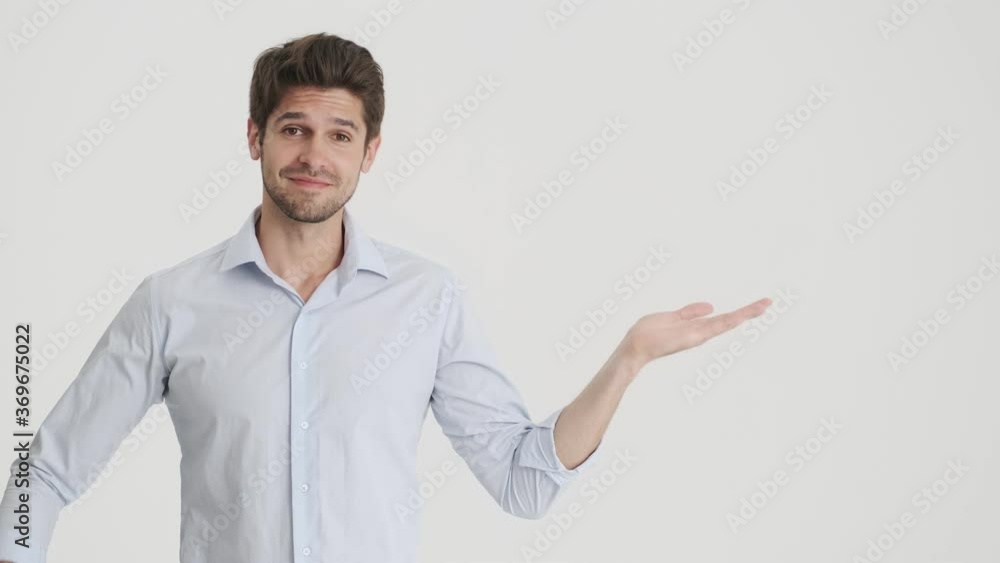 A successful man is showing free-space in his palm isolated over white background A successful man is showing free-space in his palm isolated over white background