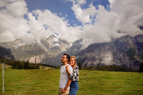 Beautiful couple posing together with mountains in background