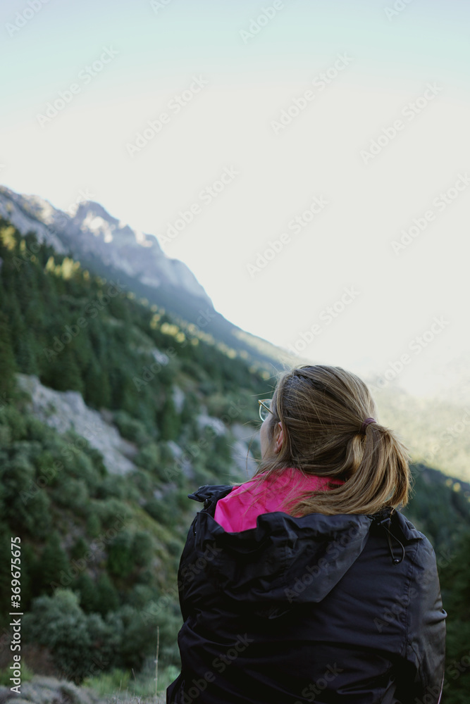 Woman in the mountains looking at view