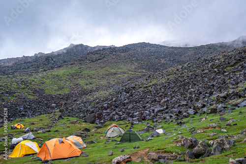 ase camp at  Ararat Mountain, approximate elevation  of 3300 meters with green pasture and rocks  is full of mountaineers in Agri, Turkey