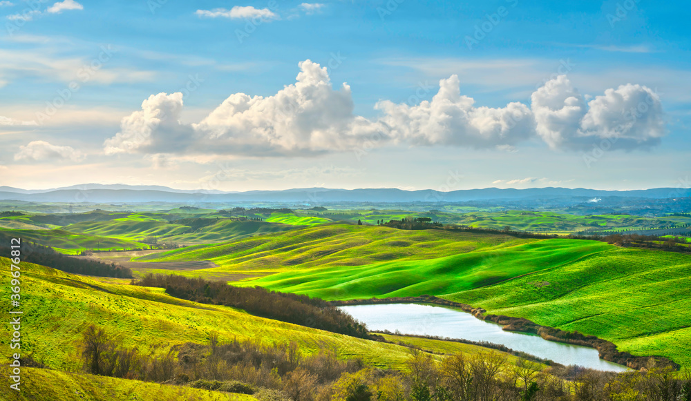 Tuscany, small lake and rural landscape on sunset, Siena Italy.