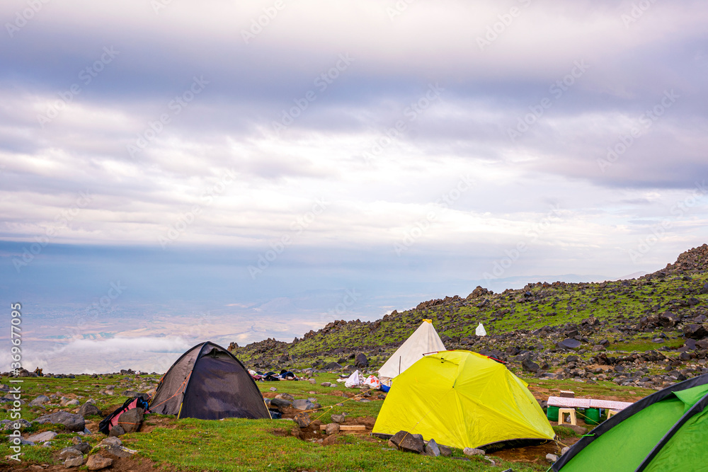ase camp at  Ararat Mountain, approximate elevation  of 3300 meters with green pasture and rocks  is full of mountaineers in Agri, Turkey