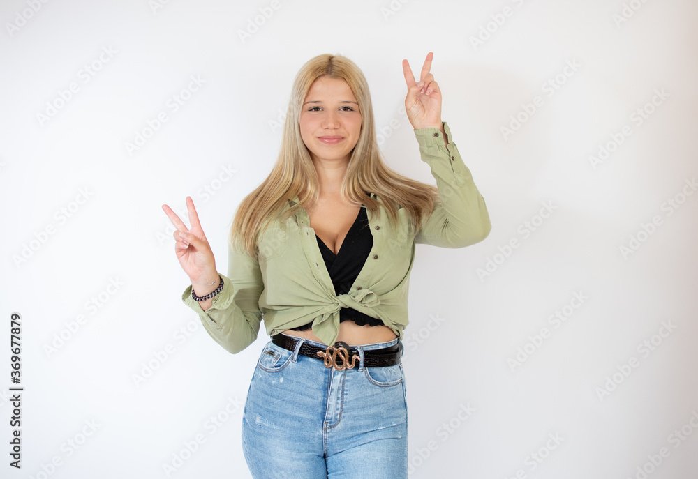 Beautiful blonde girl making finger up gesture Beautiful blonde girl making finger up gesture
