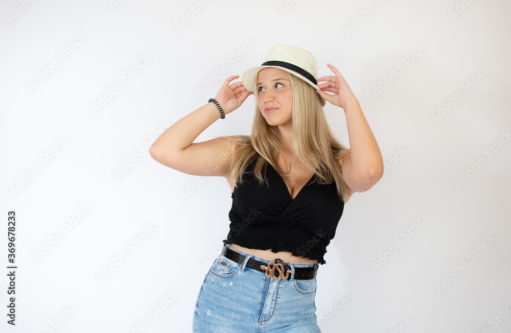Beautiful blonde girl with straw hat posing Beautiful blonde girl with straw hat posing