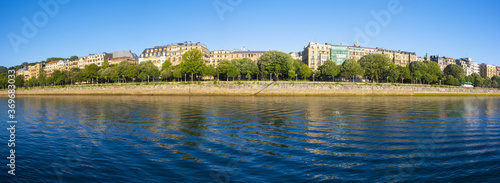 The city of Donostia is reflected in the Urumea river, Euskadi