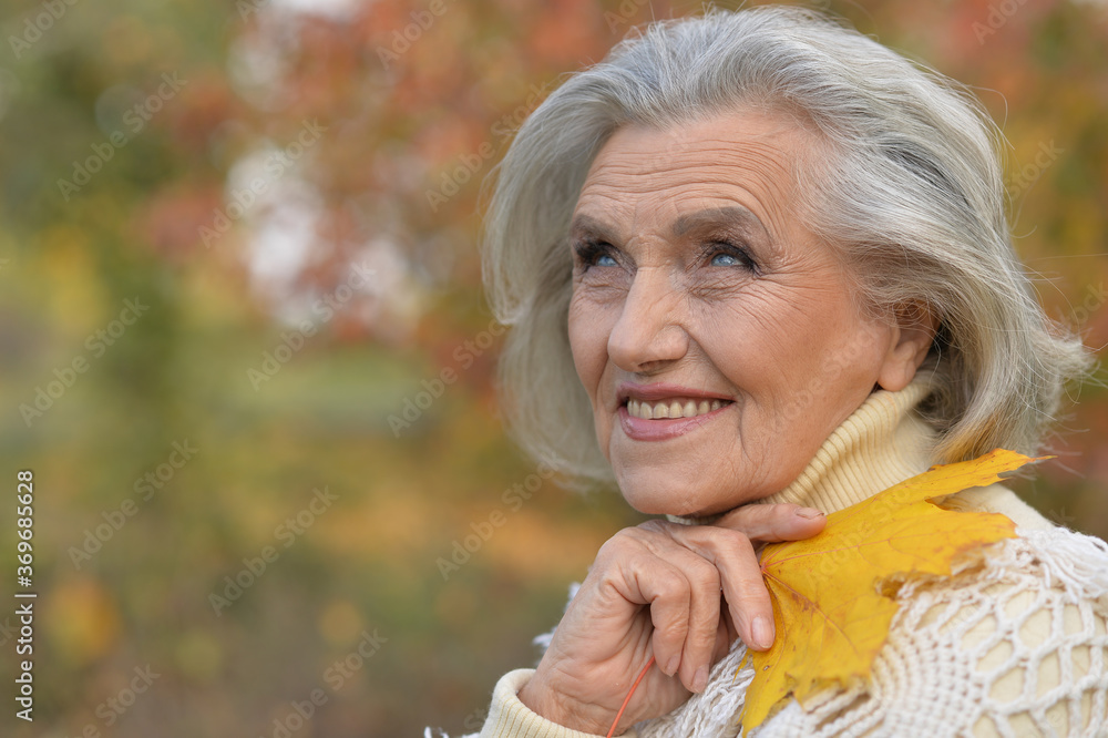 Portrait of happy senior beautiful woman in park Portrait of happy senior beautiful woman in park