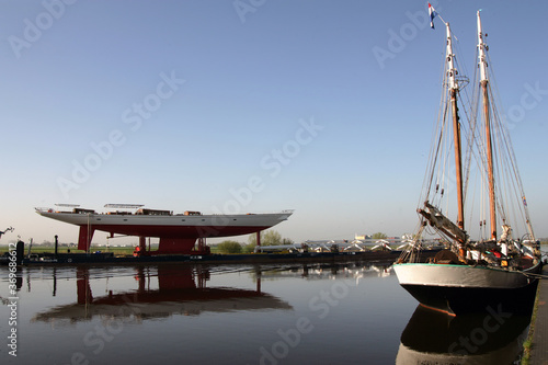 Transport superyacht. Netherlands. Sailing yacht. Shipbuilding industry. Zwartewater river Zwartsluis. Passing an old ssailing hip. photo