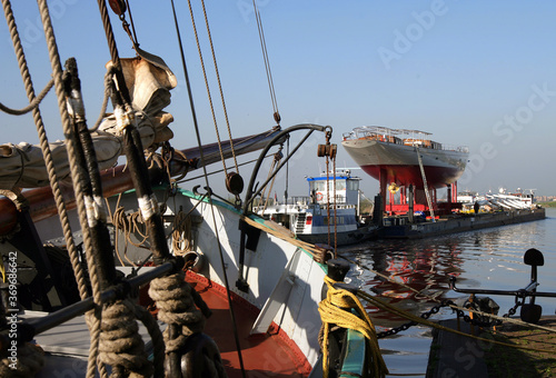 Transport superyacht. Netherlands. Sailing yacht. Shipbuilding industry. Zwartewater river Zwartsluis. Passing an old ssailing hip. photo