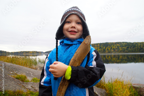 happy boy on coast lake