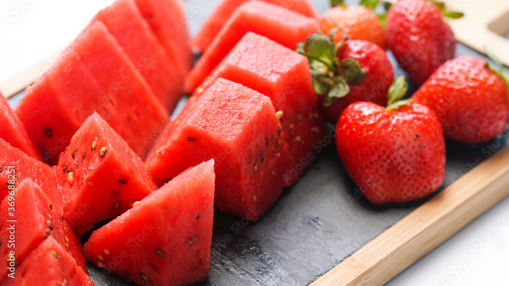 Watermelon and strawberry on the wood presentation plate Watermelon and strawberry on the wood presentation plate