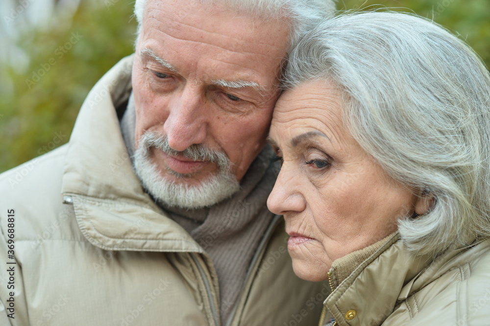 Portrait of sad thoughtful senior couple in park Portrait of sad thoughtful senior couple in park