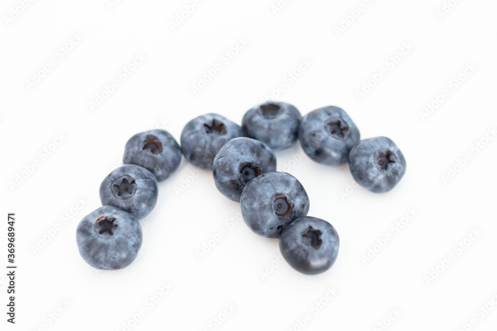 Blueberries on a white background. And also in a glass with a yellow tube. On a gray background.
Blueberries on a white background. And also in a glass with a yellow tube. On a gray background.