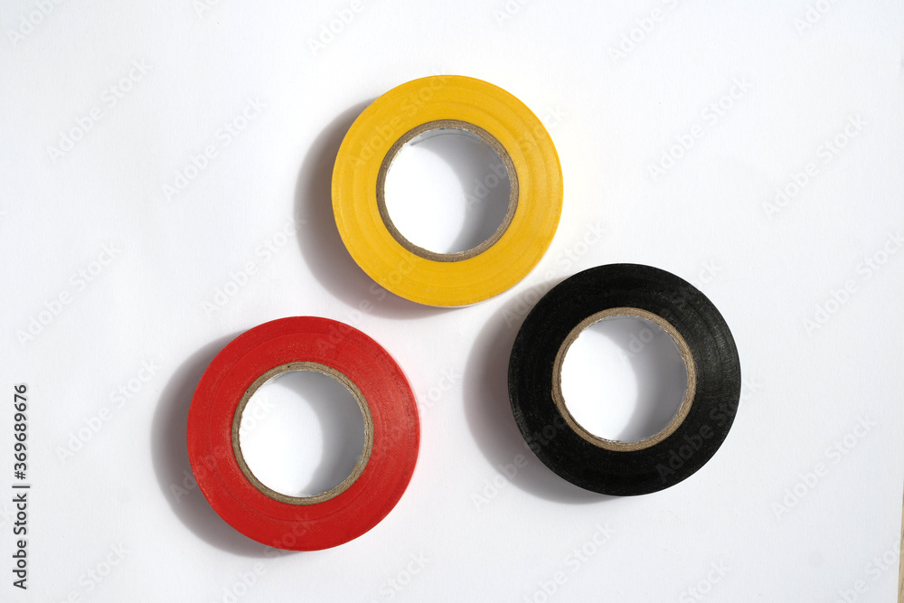 Insulation tapes: yellow, red and black for elecrics against white background Insulation tapes: yellow, red and black for elecrics against white background