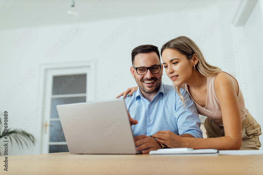 Cute couple looking at laptop, portrait. Cute couple looking at laptop, portrait.