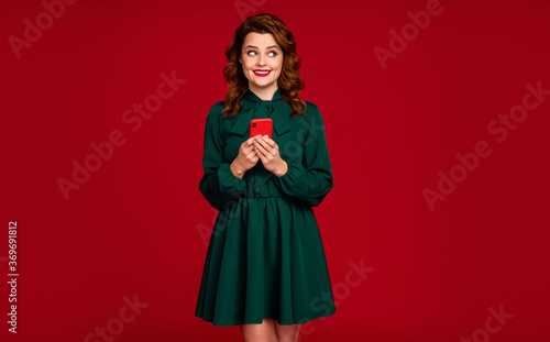 Portrait of her she nice attractive gorgeous addicted curious cheerful wavy-haired girl using digital device isolated on bright vivid shine vibrant red maroon burgundy marsala color background