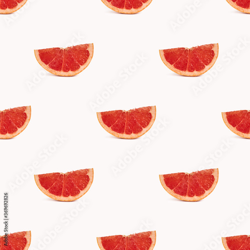 Geometric seamless pattern, grapefruit slices on a light background
