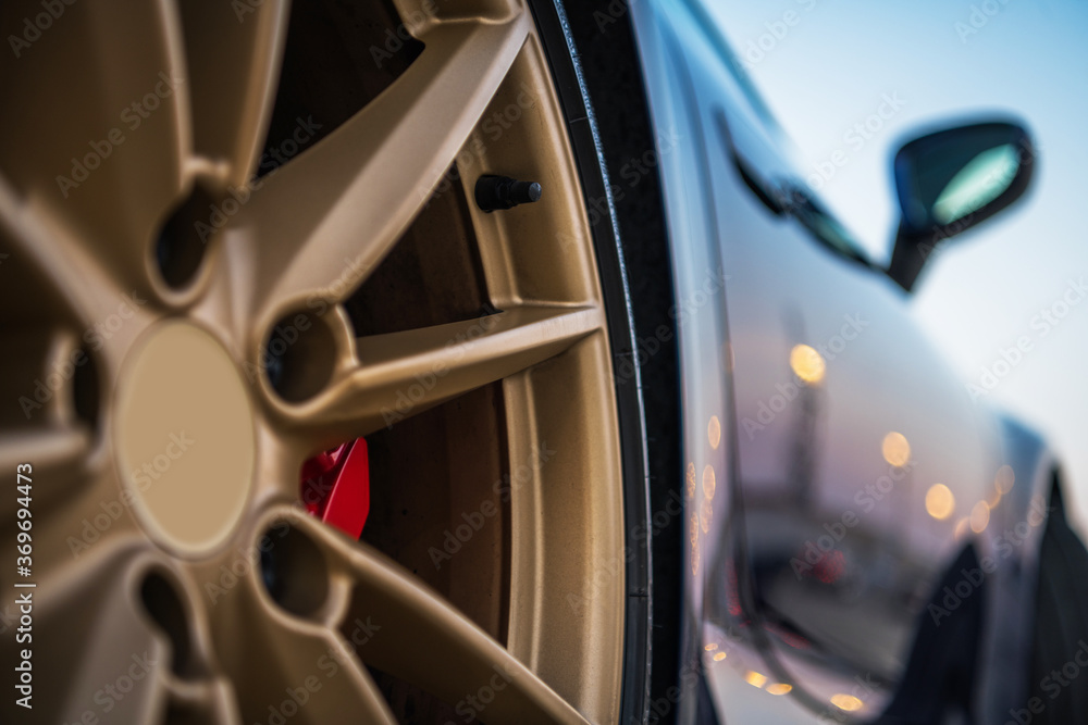 Close Up Of Golden Tire Rim Of Exotic Car. Close Up Of Golden Tire Rim Of Exotic Car.