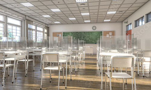 interior of a school with desks equipped with protective plexiglass screens