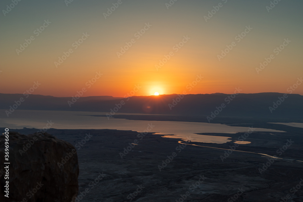 Dawn  over the mountains of Jordan and the Dead Sea. View from the territory of the ruins of the Massada fortress in Israel.