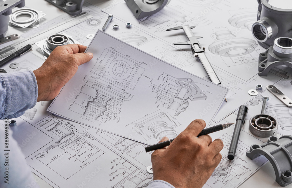 Engineer technician designing drawings mechanical parts engineering Engine.manufacturing factory Industry Industrial work project blueprints measuring bearings caliper tools Engineer technician designing drawings mechanical parts engineering Engine.manufacturing factory Industry Industrial work project blueprints measuring bearings caliper tools