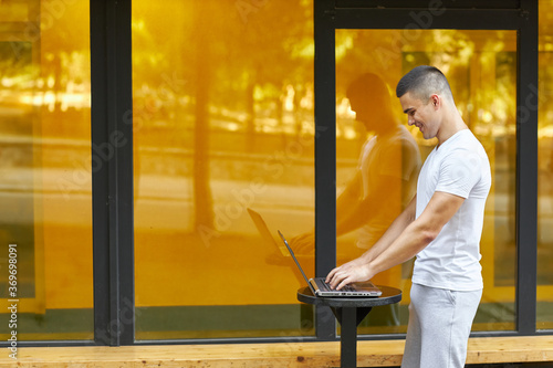 Young businessman and using modern laptop outdoors  successful manager working during break