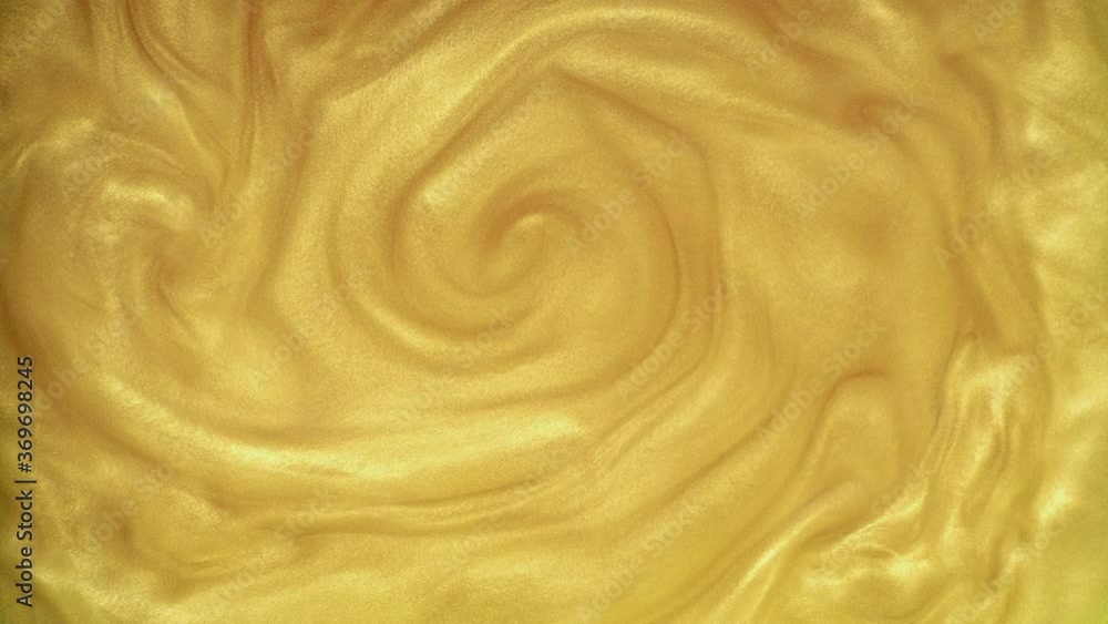 Multicolored golden sand mixed in golden liquid Multicolored golden sand mixed in golden liquid