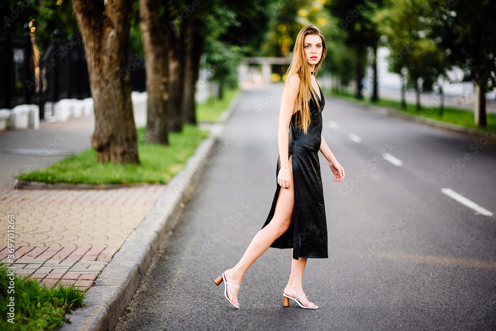 portrait beautiful girl in black dress outdoors