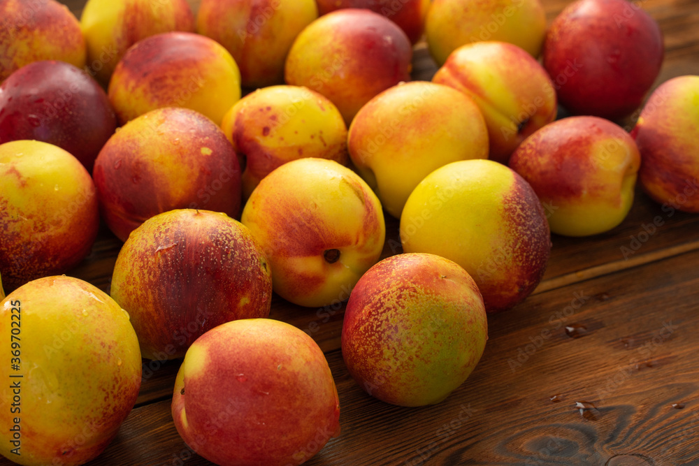 many ripe nectarines on a wooden table. fruit harvest many ripe nectarines on a wooden table. fruit harvest
