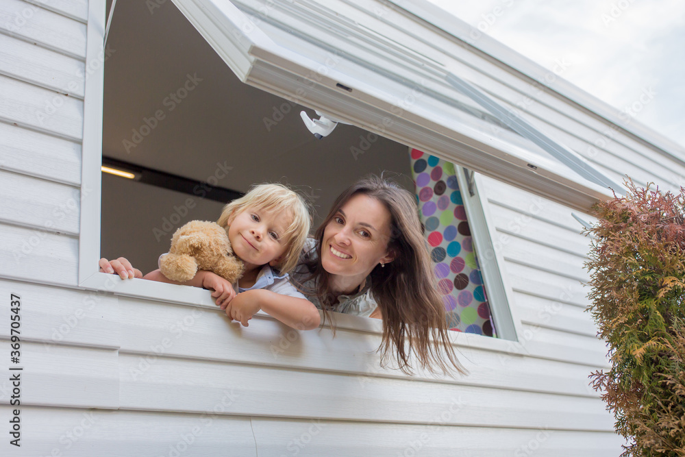 Mother and child, looking through window of mobile home Mother and child, looking through window of mobile home