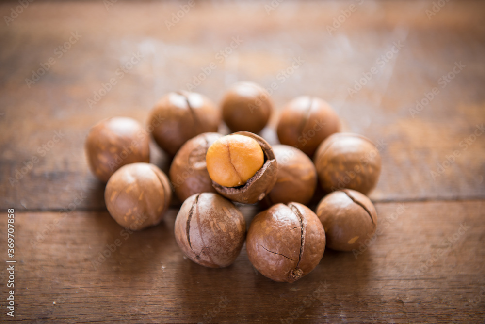 Macadamia nuts on wooden table Macadamia nuts on wooden table