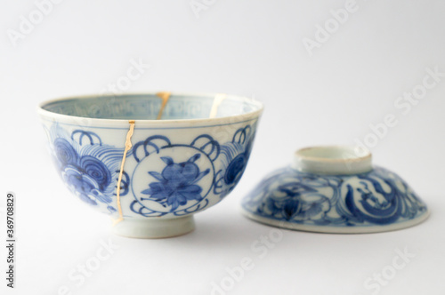 Japanese kintsugi ceramic rice bowl restored with real gold. Antique pottery kintsukuroi.