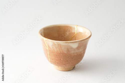 Japanese kintsugi ceramic sake cup, restored with real gold. Antique pottery kintsukuroi.  © Marco Montalti