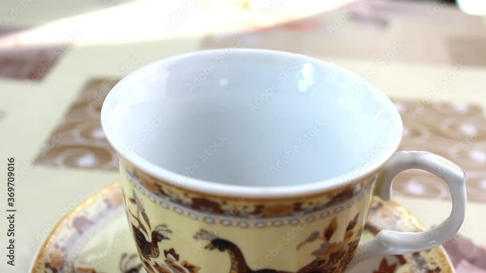 In a porcelain mug pour instant coffee, pour boiling water and mix. Close up. In a porcelain mug pour instant coffee, pour boiling water and mix. Close up.