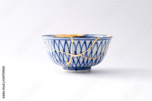 Japanese kintsugi ceramic teapot restored with real gold. Antique pottery kintsukuroi.