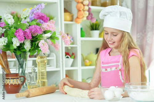 Portrait of young girl baking in the kitchen