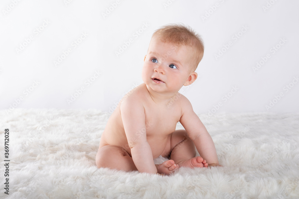 naked cute baby sitting on light background naked cute baby sitting on light background
