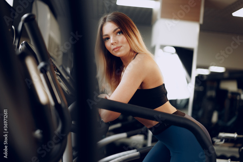 Fit curvy young blonde woman training in a cardio zone in a gym © fotofabrika