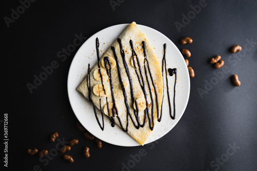Pancake with banana and chocolate topping.