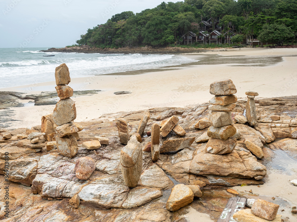 stone stack on beach in Samed, Thailand. cloudy and big waves.