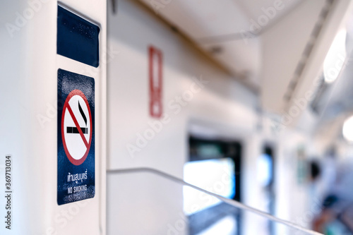 The No Smoking Sticker on the BTS train wall with blur background. (Texts on the sticker means "No Smoking")