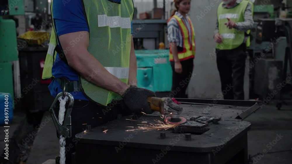 Technician or Construction worker is using electric saw in an industrial factory. Technician or Construction worker is using electric saw in an industrial factory.